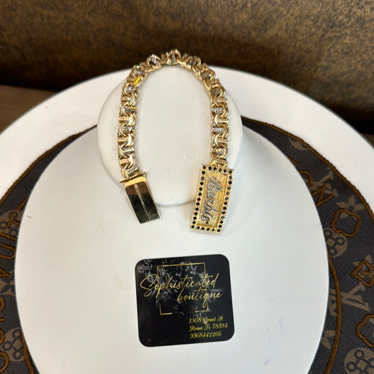 7.5” gold chinobar with name and black diamonds